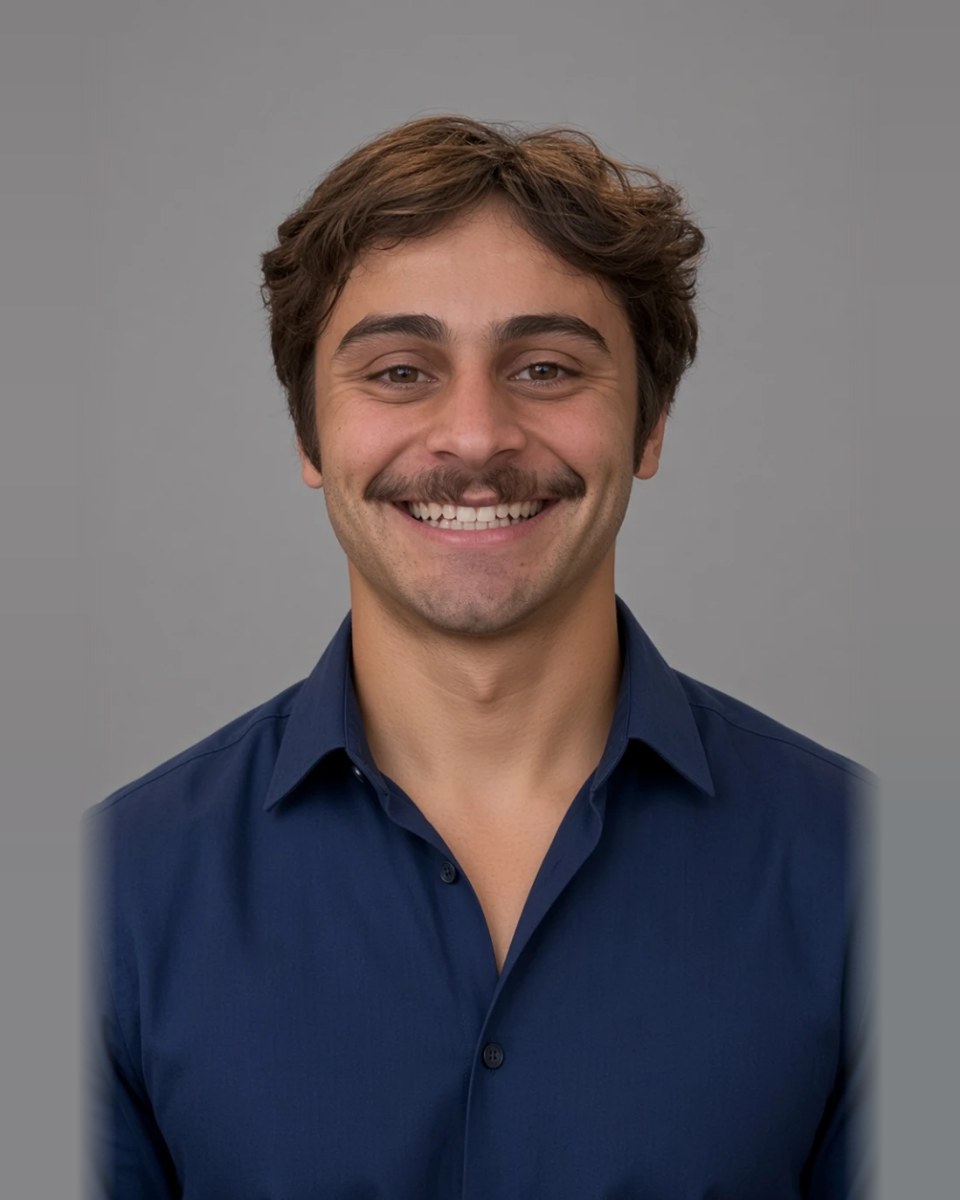 Michael, smiling, in a navy button-down shirt